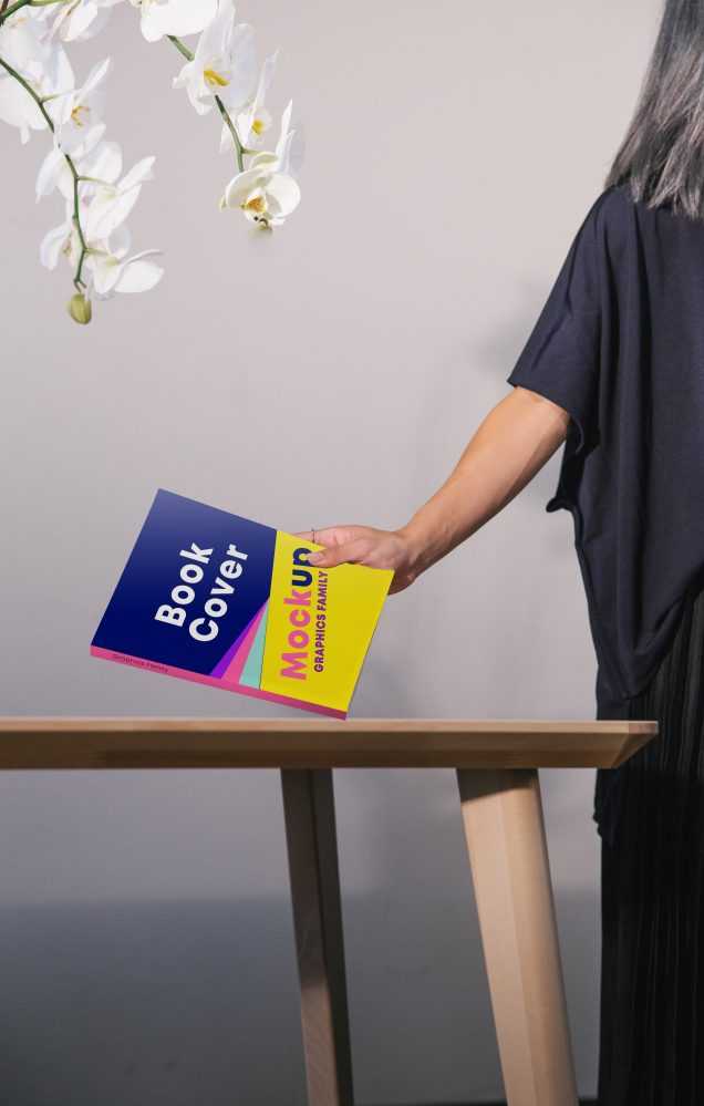 Book cover in hand mockup