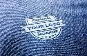 Realistic logo mockup on blue jeans or blue fabric