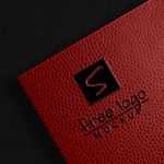2 Free Embossed Logo Mockups on Bumpy Leather in Top View