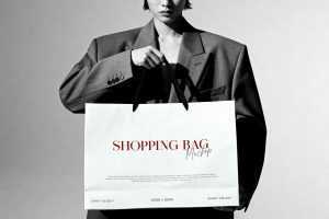 Free B&W Model Holding Shopping Bag Mockup