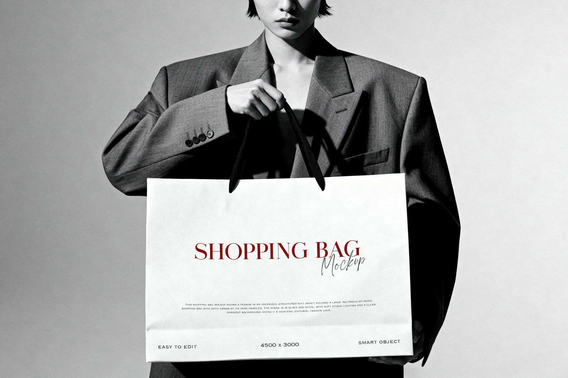 Free B&W Model Holding Shopping Bag Mockup
