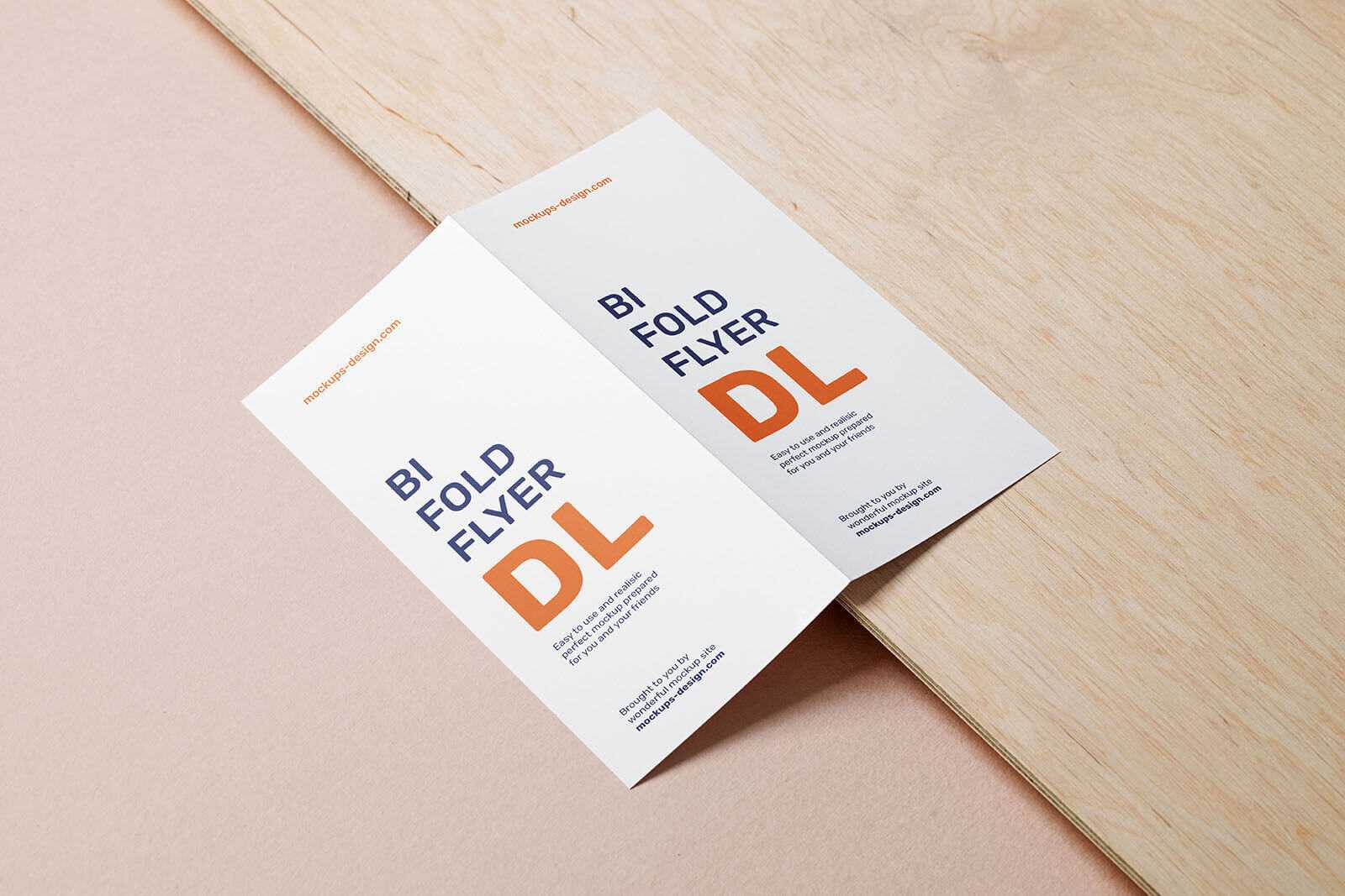 Free Bifold Dl Flyer Mockup Lying on a Wooden Board PSD