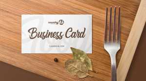 Free Business Card on Wooden Kitchen Table Mockup PSD