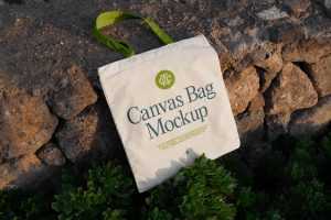 Free Canvas Bag Laying on Stones Mockup