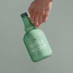 Free Ceramic Bottle in Hand Mockup