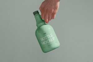 Free Ceramic Bottle in Hand Mockup