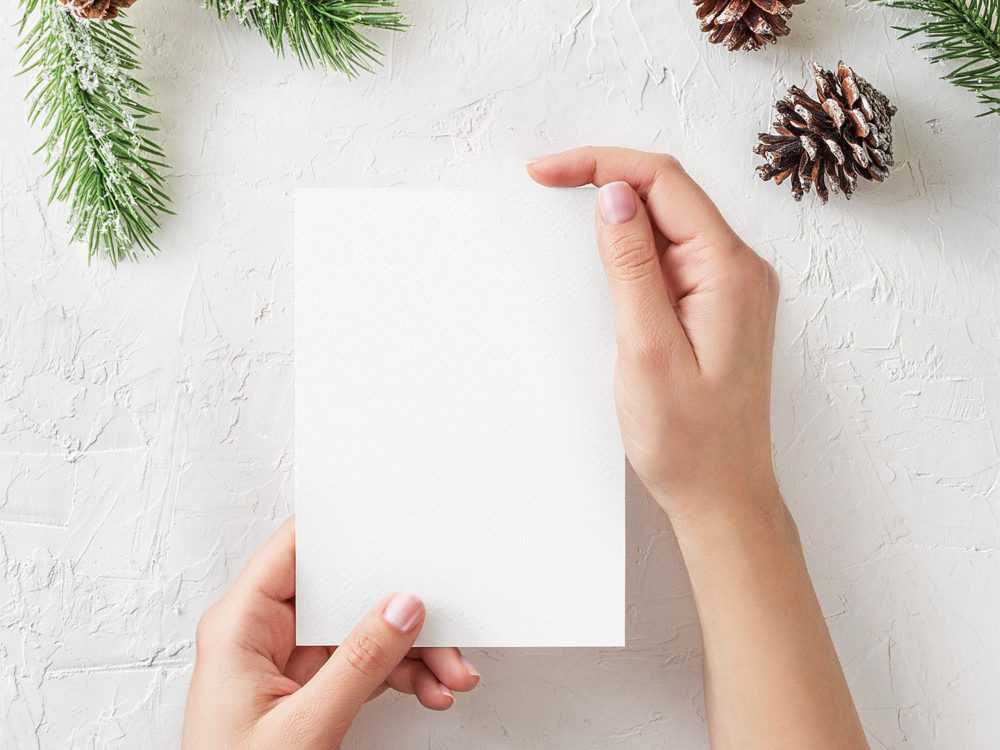 Free Christmas Card in Hand Mockup PSD