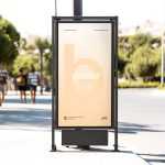 Free Citylight Board Mockup on Bright Roadside with Pedestrians