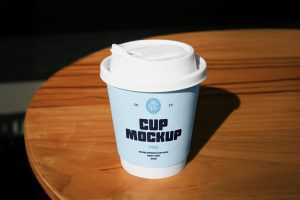 Free Coffe Cup on a Table PSD Mockup