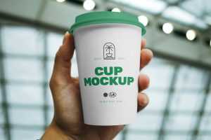 Free Coffee Cup in Hand Mockup