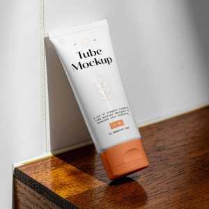 Free Cosmetic Tube Leans Against The Wall Mockup