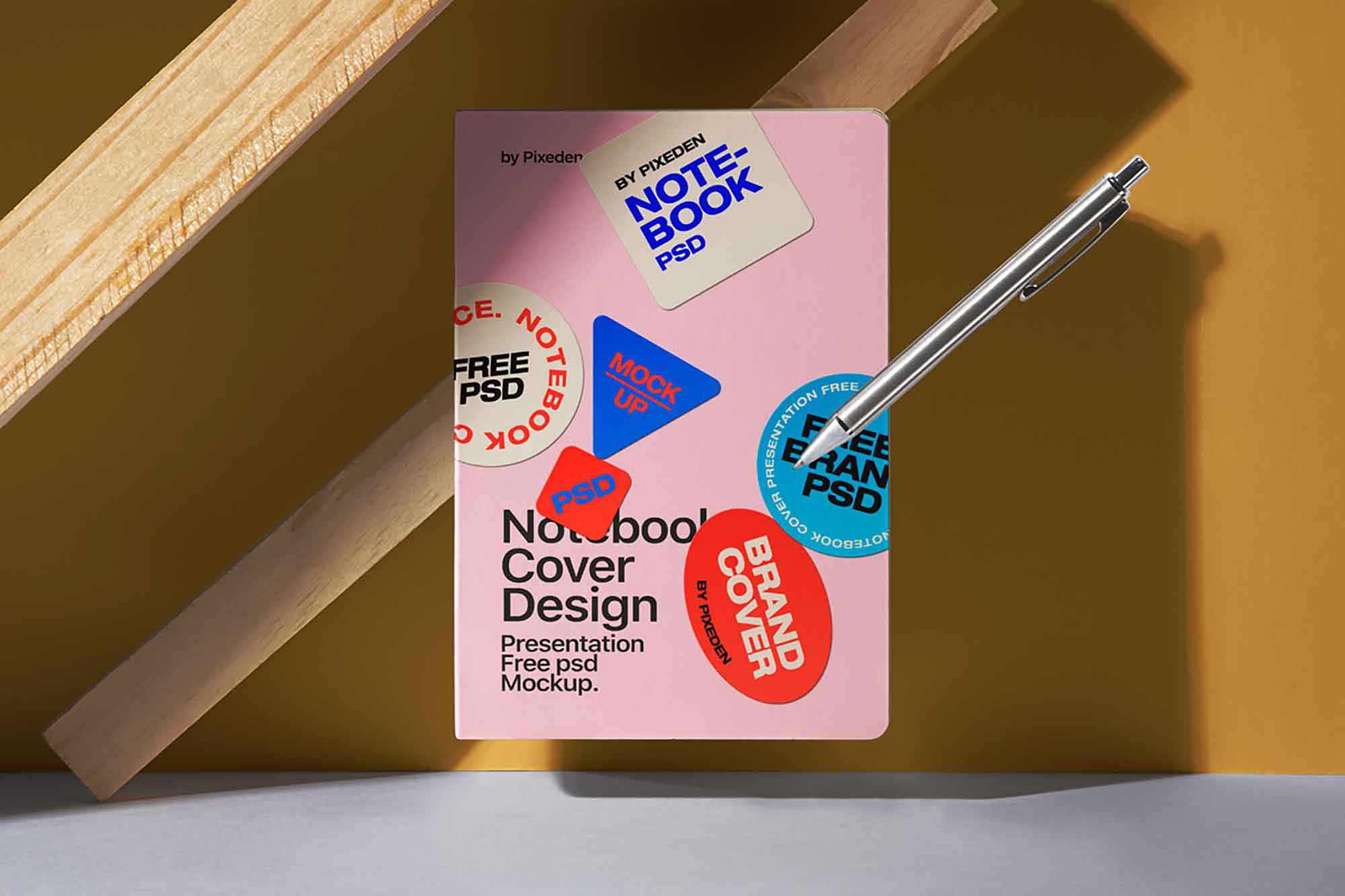 Free Floating Notebook Cover Mockup with Stick Roller Pen - Free PSD MOCKUPS | PsFiles