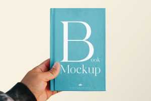 Free Hand Holding Book Cover Mockup PSD