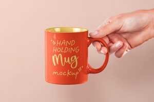 Free Hand Holding Mug PSD Mockup