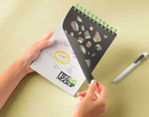 Free Hands Holding Spiral Spiral Notepad Mockup PSD