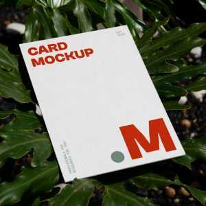 Free Laying Card Between Flowers Mockup