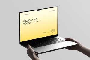 Free Macbook Pro Holding By Hand Mockup