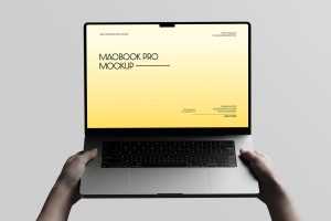 Free Macbook Pro Holding By Hand Mockup Front View