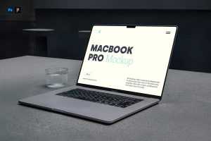 Free MacBook Pro Laying On Concrete Mockup