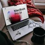 Free MacBook Pro Laying on Couch Mockup