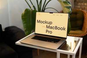 Free MacBook Pro On Small Table Mockup PSD