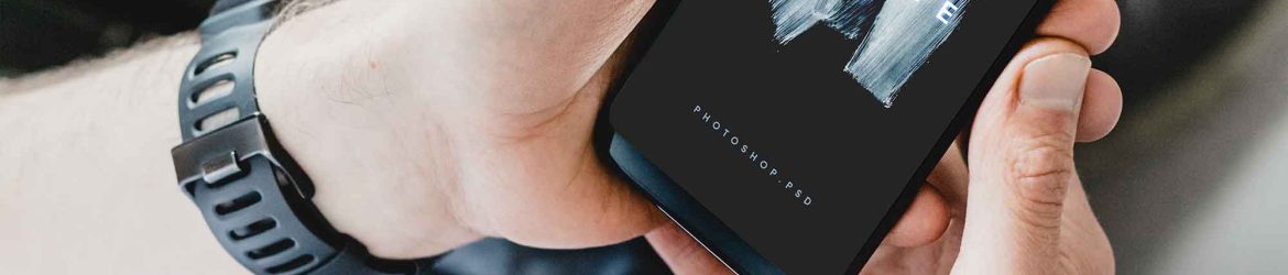 Free Man Watching his Android Phone Mockup PSD