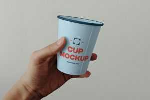 Free Paper Coffee Cup in Hand Mockup