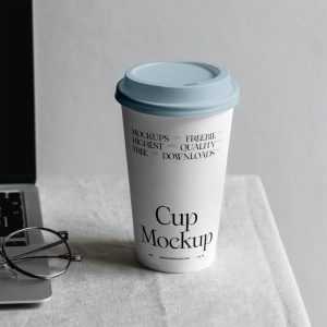 Free Paper Coffee Cup with MacBook Mockup