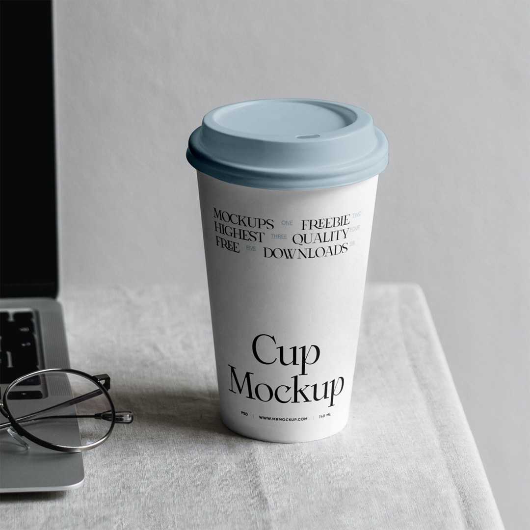 Free Paper Coffee Cup with MacBook Mockup