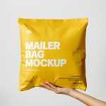 Free Square Paper Mailer Bag Mockup Holding By Hand