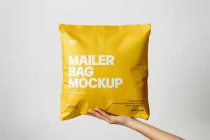Free Square Paper Mailer Bag Mockup Holding By Hand