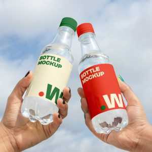 Free Two Bottle in Hand Mockups