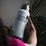 Free Woman Holding Bottle Mockup - Free PSD Download Free Woman Holding Bottle Mockup