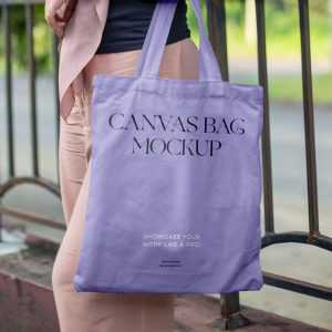 Free Woman in Park Holding Canvas Bag Mockup
