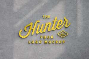 Free Yellow Glowing Logo Mockup on Wall