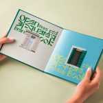 Hand Holding Hardcover Open Book Mockup PSD
