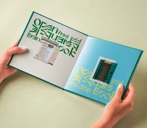 Hand Holding Hardcover Open Book Mockup PSD