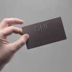 Hand Holding Logo Embossed Business Card Mockup Free PSD