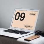Interior View of MacBook Mockup on Table with Related Items