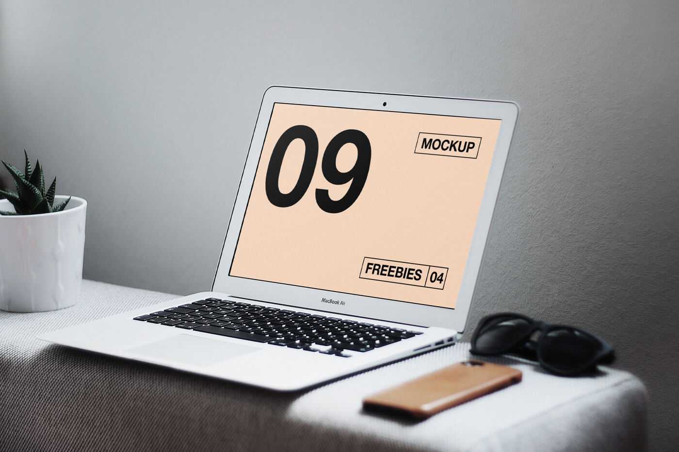 Interior View of MacBook Mockup on Table with Related Items