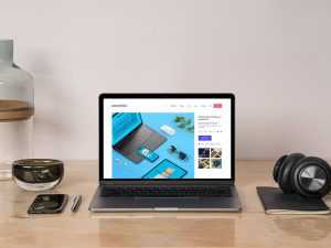 MacBook Pro Mockup on a Desk Workspace Scene Free PSD