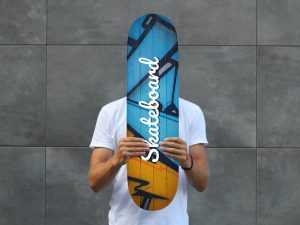 Man Holding Skateboard Mockup PSD free