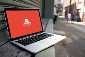 Open Laptop Mockup PSD on in Front of Street Shop Free PSD