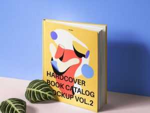 Standing Hardcover Book and Leaves Mockup