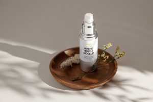 Airless bottle on wooden tray mockup