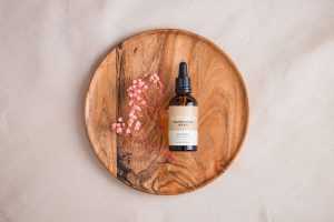 Amber bottle with dried flowers mockup
