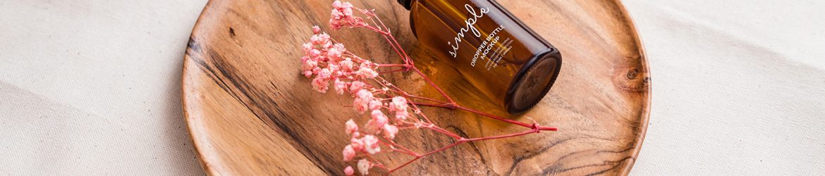 Amber dropper bottle on wooden tray mockup Amber dropper bottle on wooden tray mockup