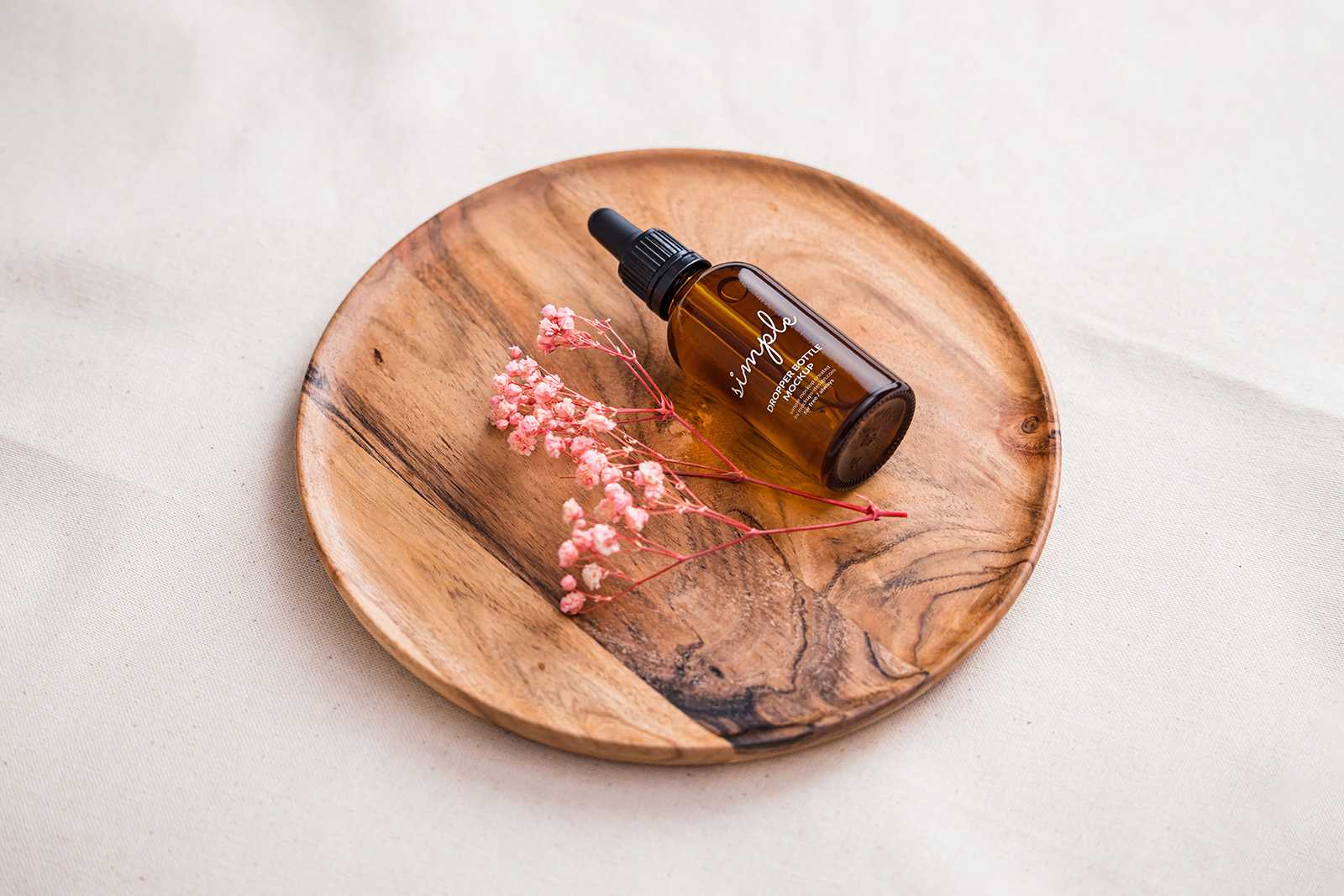 Amber dropper bottle on wooden tray mockup