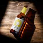 Beer bottle on wooden background mockup