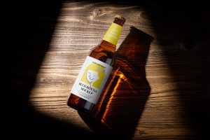 Beer bottle on wooden background mockup